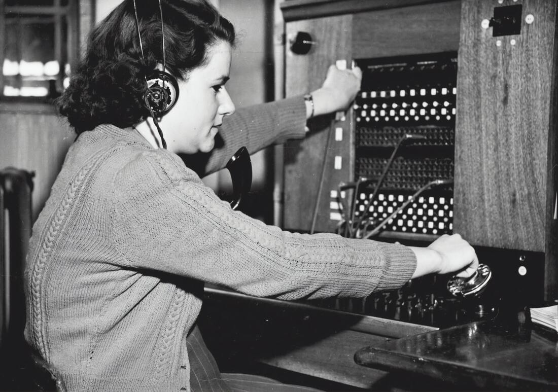 Old fashioned switchboard operator connecting a call